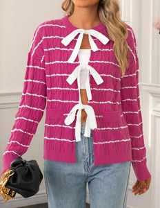 Detail of plum purple striped knit cardigan featuring white bow tie closures for women