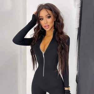 Close-up of the front metal zipper on a slim fit black long sleeve bodysuit jumpsuit