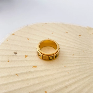 Close-up of golden rotating ring with traditional Chinese Mahjong character engravings