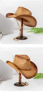 Detailed macro of the vintage straw cowboy hat featuring silver bull head buckle and texture