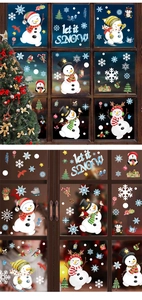 Detail showing watercolor snowman window stickers with snow and penguin holiday motifs