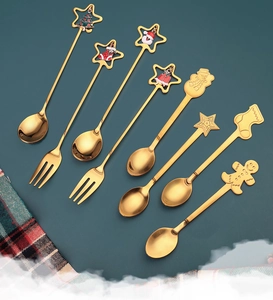 Detail view of 8-piece gold stainless steel Christmas spoons and forks with festive charms