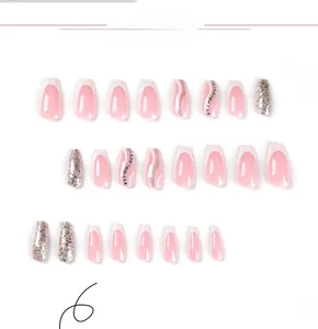 Detail of pink French press-on nails with silver glitter, white tips, and small rhinestones