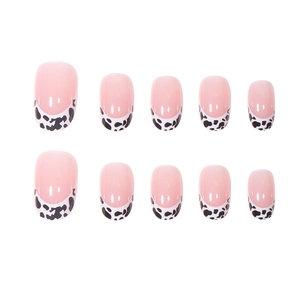 French tip press-on nails with black and white cow print and glossy pink base finish