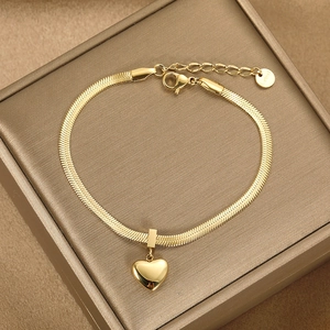 Elegant gold stainless steel flat snake chain bracelet with heart pendant on satin