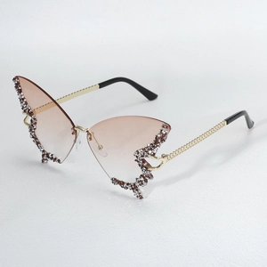 Exaggerated butterfly rhinestone sunglasses with gradient lenses and stylish chain temples.