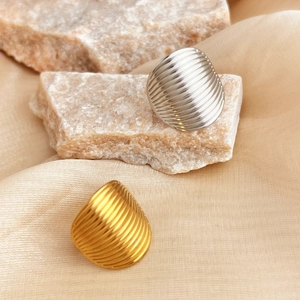 Retro striped oval rings in gold and silver finish displayed on elegant champagne satin
