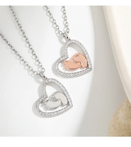 Detail view of heart necklace with baby footprints and sparkling cubic zirconia stones