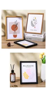 Detail of minimalist wood and black frames featuring Matisse style abstract wall art prints