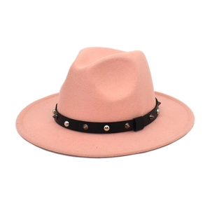 Detailed view of pink wool fedora hat with black leather belt and silver metal studs