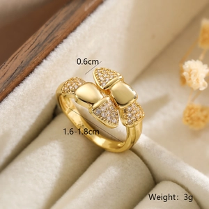 Detail shot of a gold-plated geometric ring with zircon stones in a velvet box