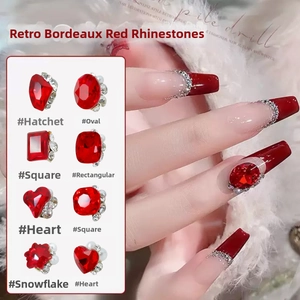 Detailed view of Bordeaux red crystal nail rhinestones in eight assorted shapes