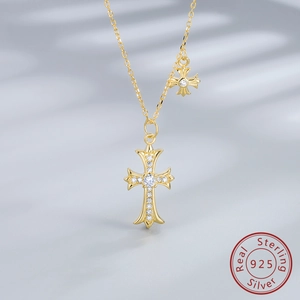 Detail of gold-plated 925 silver double cross necklace featuring sparkling zircon stones