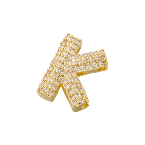 Macro view of gold-plated letter K pendant with cubic zirconia inlay and side hole