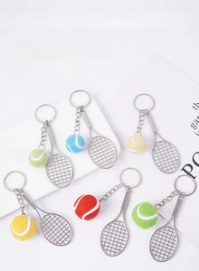 Vue détaillée de mini porte-clés raquettes de tennis avec balles colorées sur fond blanc