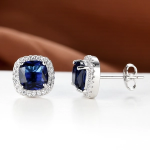 Elegant square cushion-cut blue sapphire earrings with white diamond halo and silver pins