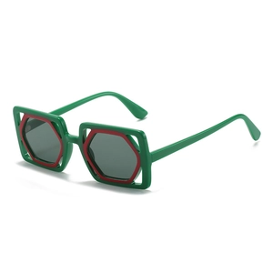 Fashionable large square sunglasses with green frames and contrasting red hexagonal inserts