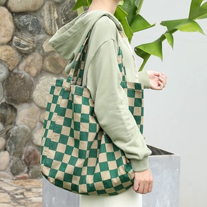 Green checkerboard canvas tote bag stylish casual shoulder bag shown in outdoor setting