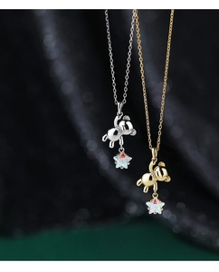 Close-up of S925 silver bear pendants with shimmering star stones in gold and silver