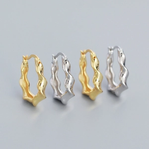 Irregular wavy S925 silver hoop earrings in gold and silver finish on a grey background