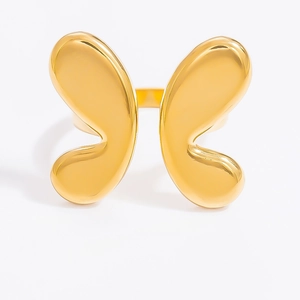 Detailed close-up of 18k gold butterfly ring with polished finish on white background