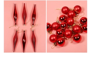 Detail of red festive Christmas ornaments including round and wavy shaped decorative balls