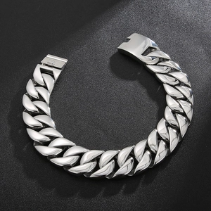 Close-up of a chunky silver Cuban link chain bracelet with a secure box clasp mechanism