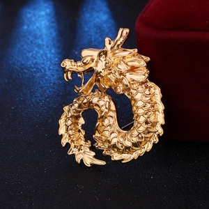 Detailed close-up of golden dragon brooch showing intricate texture and majestic design