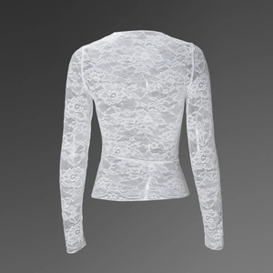 Detail view of the intricate floral lace pattern on back of white long sleeve top