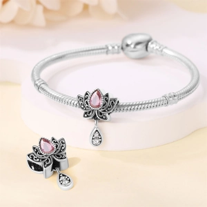 Detail of silver bead with pink teardrop crystal and floral design on snake chain