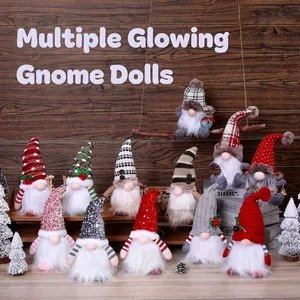 Illuminated Christmas gnomes with knitted hats and long white beards on a cozy wooden shelf