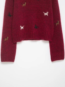 Detailed macro view of the mohair knit hem with elegant animal embroidery and ribbing