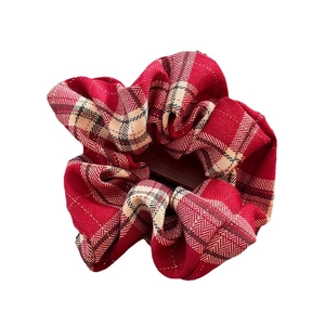Elegant red plaid lace scrunchie hair tie with classic tartan pattern and woven fabric texture