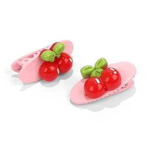 Pink duckbill hair clips with red cherry and green leaf decorations in resin material