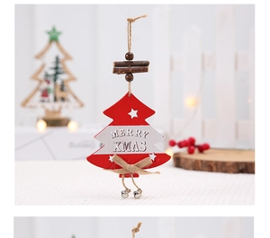 Detail of wooden Christmas tree ornament with Merry Xmas text and metal bell
