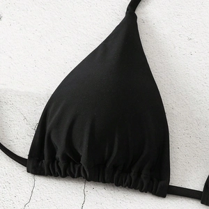 Detail of black triangle bikini top with ruched texture and adjustable drawstring design