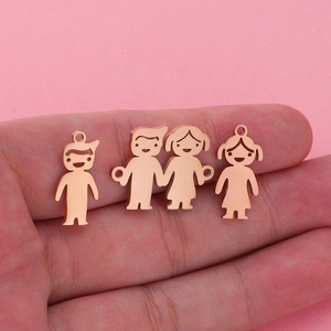 Detailed view of rose gold stainless steel boy and girl shaped pendants on hand