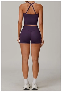 Detail of cross-back strap design on a purple brushed yoga vest with matte texture