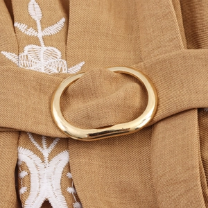Elegant camel blouse with lace patchwork, golden buckle belt, and floral embroidery details