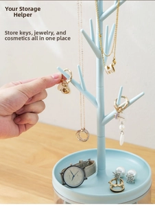 Close-up of light blue branch-shaped jewelry organizer with a round tray for rings