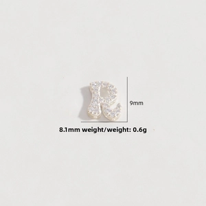 Detailed macro view of S925 silver letter R charm micro-paved with sparkling zircon stones