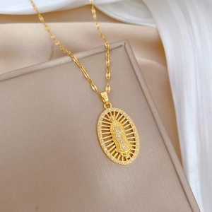 Gold oval Virgin Mary necklace with crystal halo on a jewelry display box