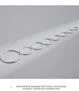 Macro detail of S925 sterling silver hoop earrings set in eight graduated sizes