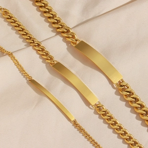 Macro detail of three 18K gold-plated stainless steel ID bracelets in different thicknesses