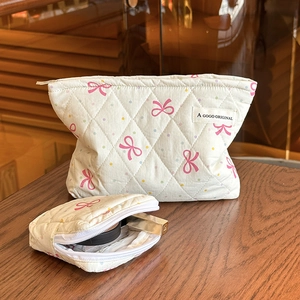 Quilted makeup bag set with pink bows and colorful polka dots on creamy fabric