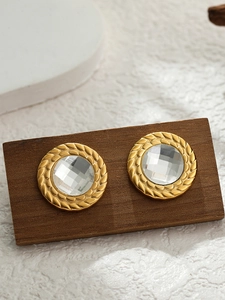 Macro shot of 18K gold-plated round earrings with crystal in vintage twisted rope frame