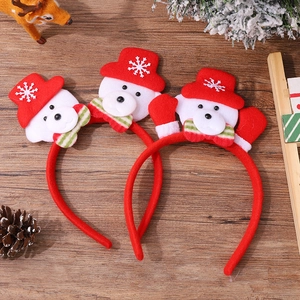 Christmas reindeer antler headband set with plush snowmen on a festive wooden background