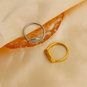 Macro detail of dual-tone hammered texture rings on elegant champagne satin fabric