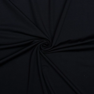 Close-up of black pleated fabric texture with elegant spiral draping and soft sheen