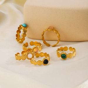 Vintage style gold adjustable rings with turquoise and onyx stones on silk fabric